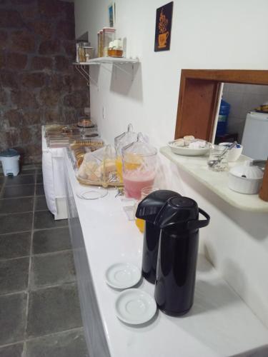 a counter in a kitchen with some food on it at Pousada Recanto da Praia Grande Paraty in Paraty