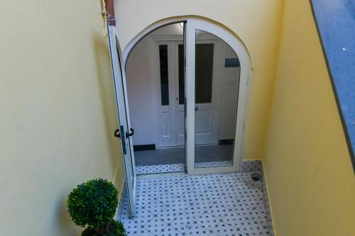 a mirror in a hallway next to a door at L'Aurora Azzurra -Luxury Suites Sorrento coast in Piano di Sorrento