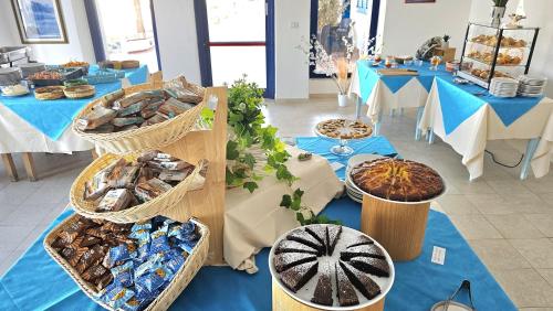 a buffet of food on tables in a room at Vel Marì - Rooms on the Beach in Alghero