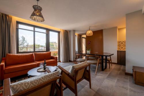 a living room with a couch and a table at Zaria Court Hotel Kigali in Kigali