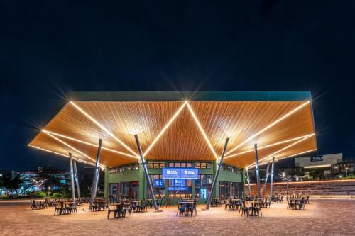 a building with tables and chairs at night at Zaria Court Hotel Kigali in Kigali