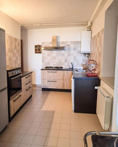 a kitchen with a stove and a sink in it at Casa di Adele in Brittoli