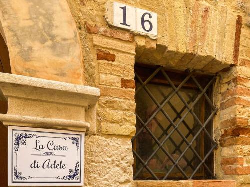 a sign on the side of a building with a window at Casa di Adele in Brittoli