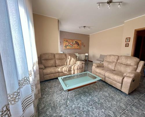 a living room with two couches and a table at Molise Rigenera in Isernia