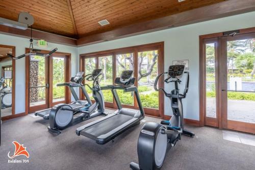 a fitness room with treadmills and elliptical machines at 2BR bright quiet condo in Kulalani sleeps 6 in Waikoloa