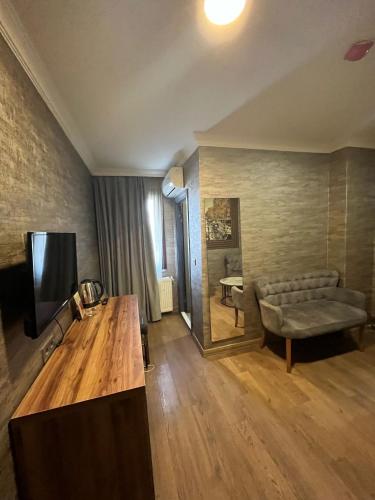 a living room with a couch and a television at La Vie Suite Hotel in Istanbul