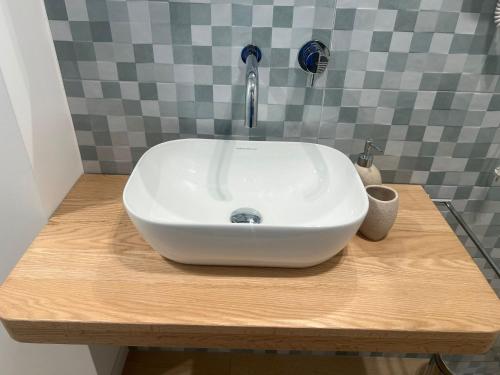 a white sink sitting on top of a wooden counter at FLAIC b&b in Pergusa