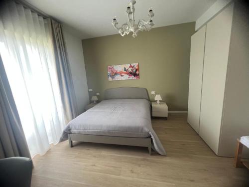 a bedroom with a bed and a chandelier at FLAIC b&b in Pergusa
