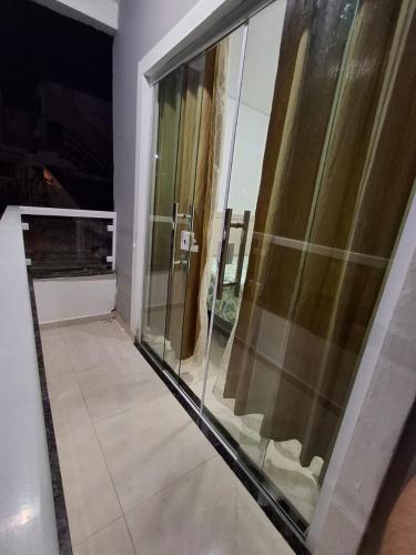 a large glass shower in a room with at Kitnet - Itabuna-Ba in Itabuna