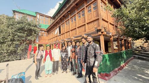 a group of people standing in front of a building at The velox Traditional Home Stay in Kalpa