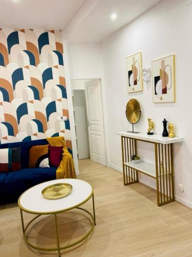 a living room with a couch and a table at Appartement hyper centre Balcon in Périgueux