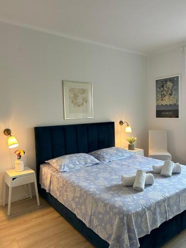 a bedroom with a blue bed with two pillows on it at Apartman Andra in Split