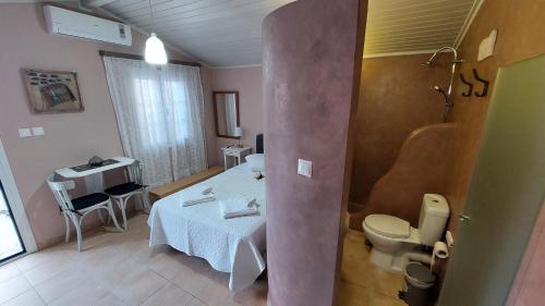 a small room with a bed and a bathroom at Niriides Apartments & Studio in Vathi