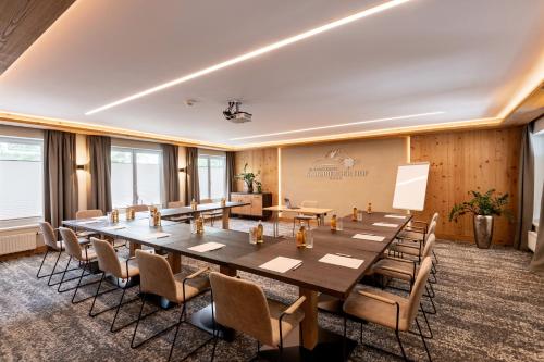 a large conference room with a large table and chairs at Alpen Glück Hotel Kirchberger Hof in Kirchberg in Tirol