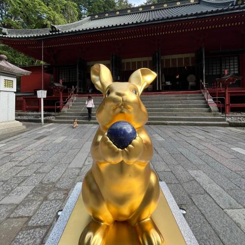 a statue of a dog with a ball in its mouth at Sanga Nikko in Nikko