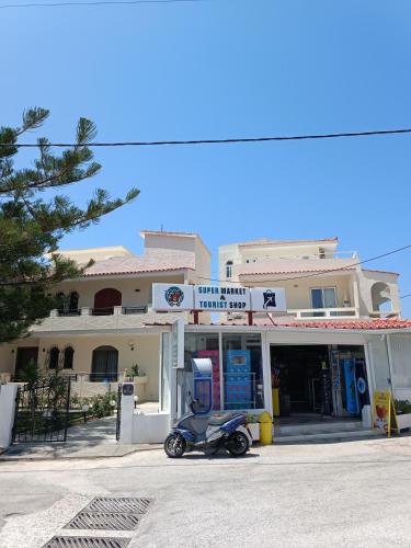 a scooter parked in front of a gas station at Maria Studios & Apartments in Kremasti