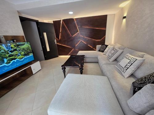 ein Wohnzimmer mit Couch und Flachbildfernseher in der Unterkunft Ajanif Apparte Standing et Fraicheur Salon et Suite Parentale Climatise in Tétouan
