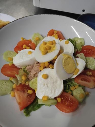 a plate of food with eggs and vegetables on it at Hotel Villa Orio & Beatrice in Venice-Lido