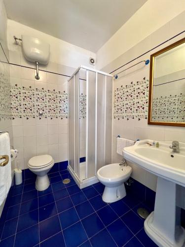 a bathroom with a toilet and a sink and a shower at Villa Edelweiss in Bacoli