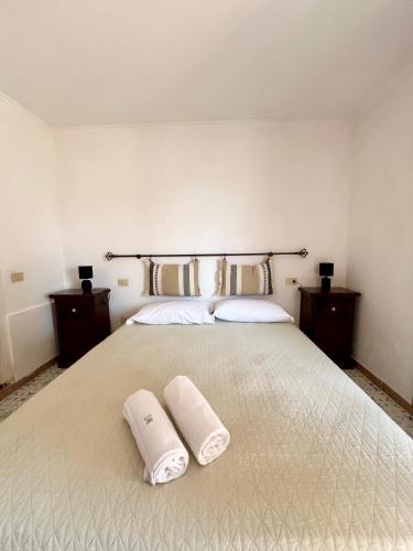 a bedroom with a large bed with two towels on it at Villa Edelweiss in Bacoli