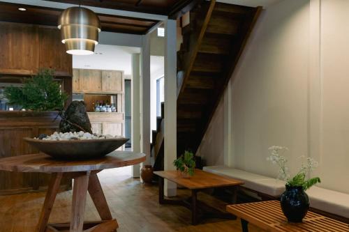 a living room with a staircase and a bowl on a table at LA TERRA narai in Shiojiri
