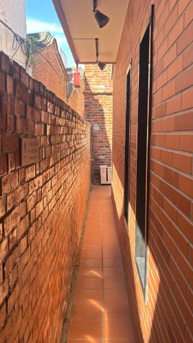 a brick alley way with a brick wall at 鹿厝老街民宿 in Lugang