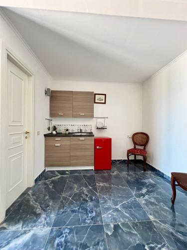 an empty room with a kitchen with blue tiles on the floor at Villa Edelweiss in Bacoli