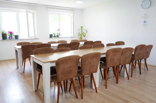a conference room with a large table and chairs at Hotel AKSU in Bucharest