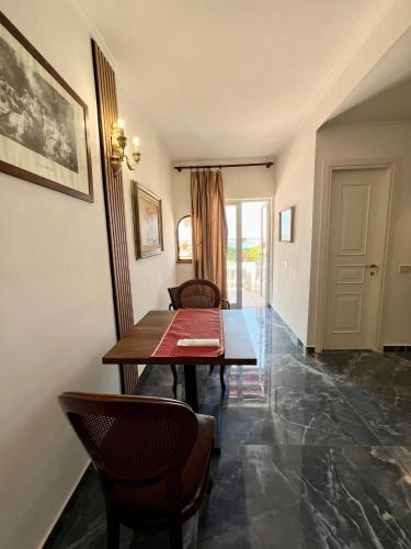 a dining room with a table and chairs at Villa Edelweiss in Bacoli