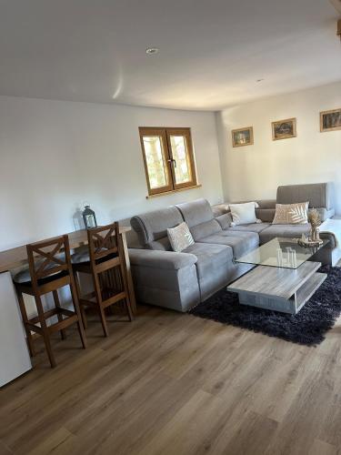 a living room with a couch and a table at Domek z balią in Zwierzyniec
