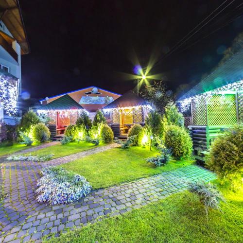 a house decorated with christmas lights at night at Laguna in Slavske