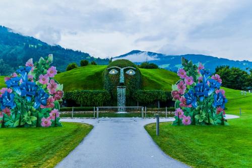 a statue of a head in a field with flowers at Lovely Apartment in the Old Town in Hall in Tirol