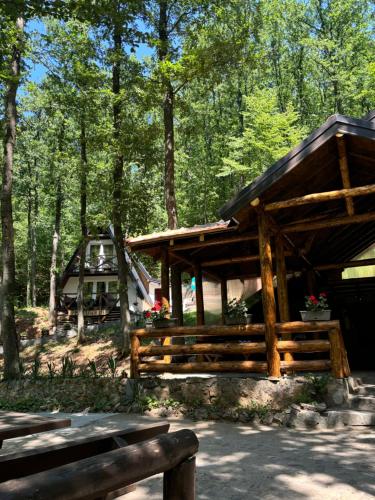 a wooden pavilion in the middle of a forest at Vila KTM Lisine in Despotovac