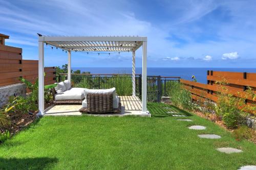 a gazebo with a couch on a lawn at Villa Kintana - Piscine - SPA - Prestations 5 Etoiles in Petite Île