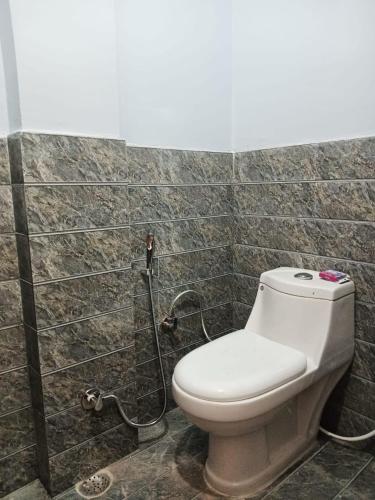 a bathroom with a toilet and a shower at Independent homestay in Dehradun