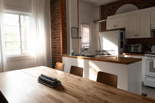 une cuisine avec une table en bois et un couteau. dans l'établissement Perfect for Groups Big Livingroom 2 Backyard 3BR, à Montréal