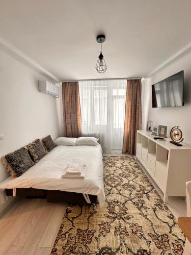 a bedroom with a bed and a large window at Cristina Dreams Apartaments in Botoşani
