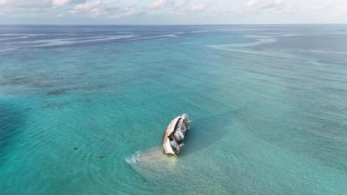 a boat in the water in the ocean at MEHEL - Holiday Home - Mahibadhoo in Mahibadhoo