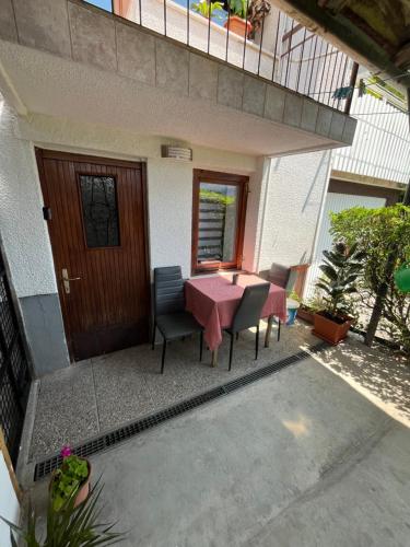 a patio with a table and chairs in front of a house at Stanojkov 2 in Bovec