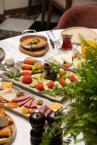 a table with plates of food on a table at Querencia Hotel in Istanbul