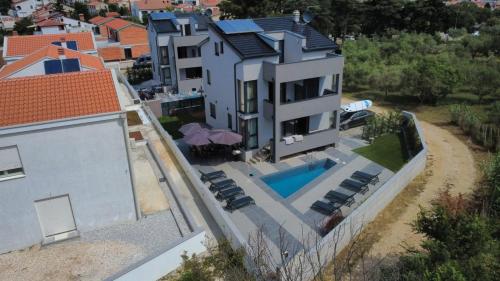 an aerial view of a house with a swimming pool at VAL22,VILLA 200 m from BEACH WITH POOL AND FITNESS in Funtana