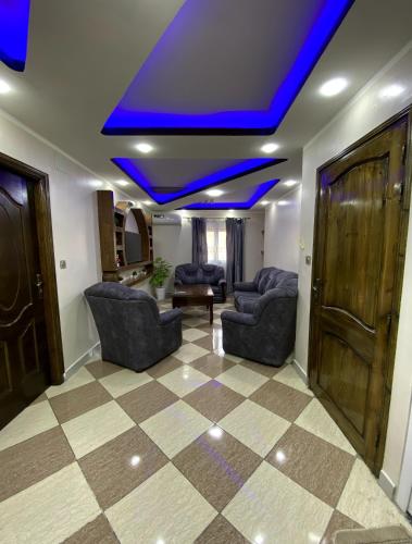 a living room with couches and a blue ceiling at Adem in 'Aïn el Turk