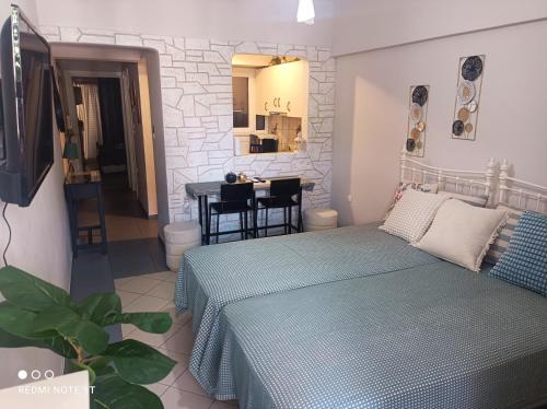 a bedroom with a bed and a table in a room at central sweet home in Larisa