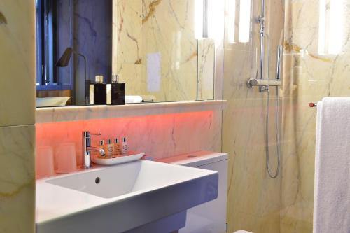 a bathroom with a sink and a shower at Pestana CR7 Lisboa in Lisbon