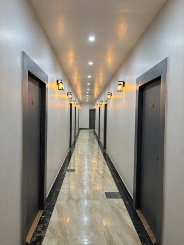 a hallway with a row of doors in a building at The Narendra hotel 700m away from the Ram Mandir in Ayodhya