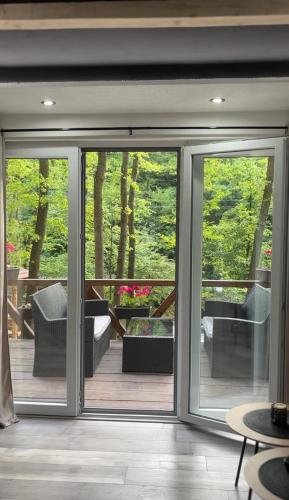an open sliding glass door in a house with a patio at Planinska vila KTM Lisine in Despotovac