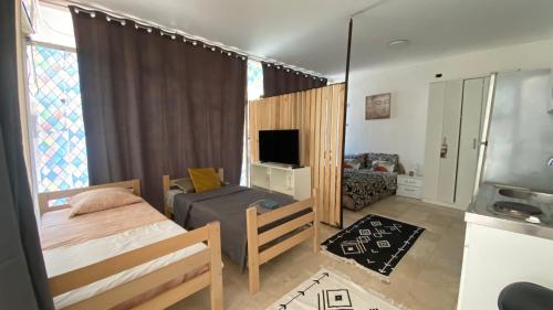 a bedroom with a bed and a tv and a couch at Boho Old Town Budva in Budva