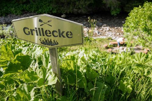 a sign in the middle of a garden at Am Gehren - Arlberg Appartements in Warth am Arlberg