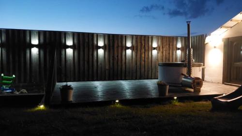a backyard with a wooden fence at night at Gościniec u Bobaków in Ząb