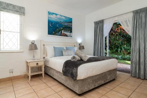 a bedroom with a large bed and a window at Relaxing Seaside Escape at 2 Perissa in Ballito